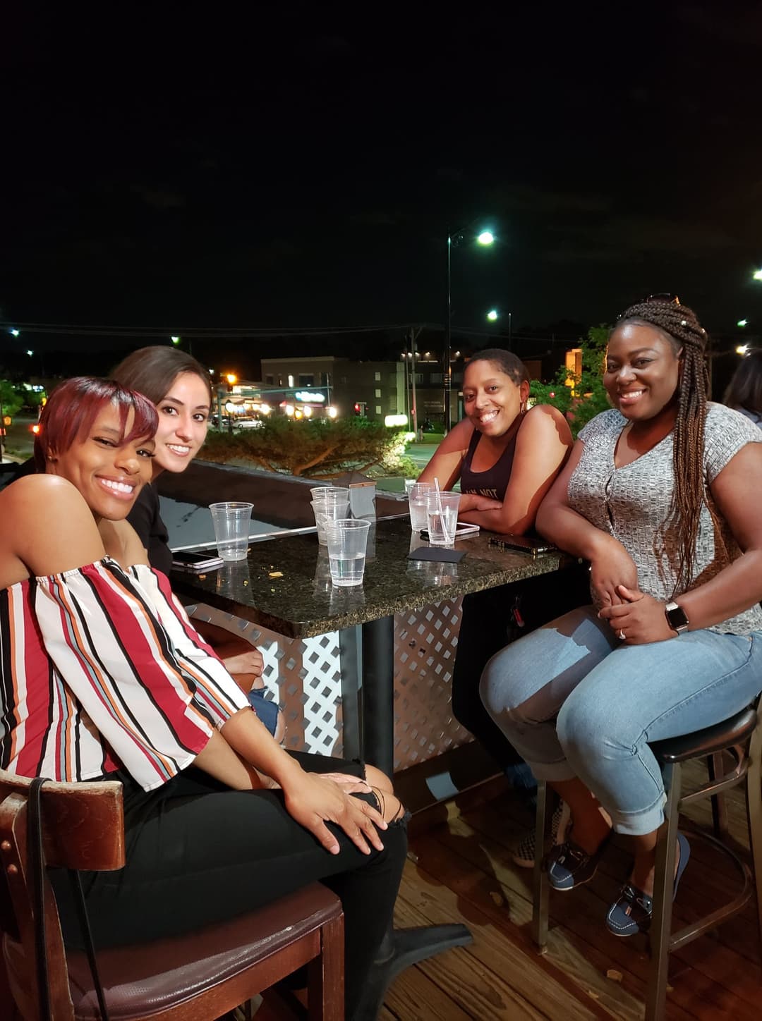 Guests dining at night on the rooftop patio at Rooftop Johnnys in Palos Heights, Illinois