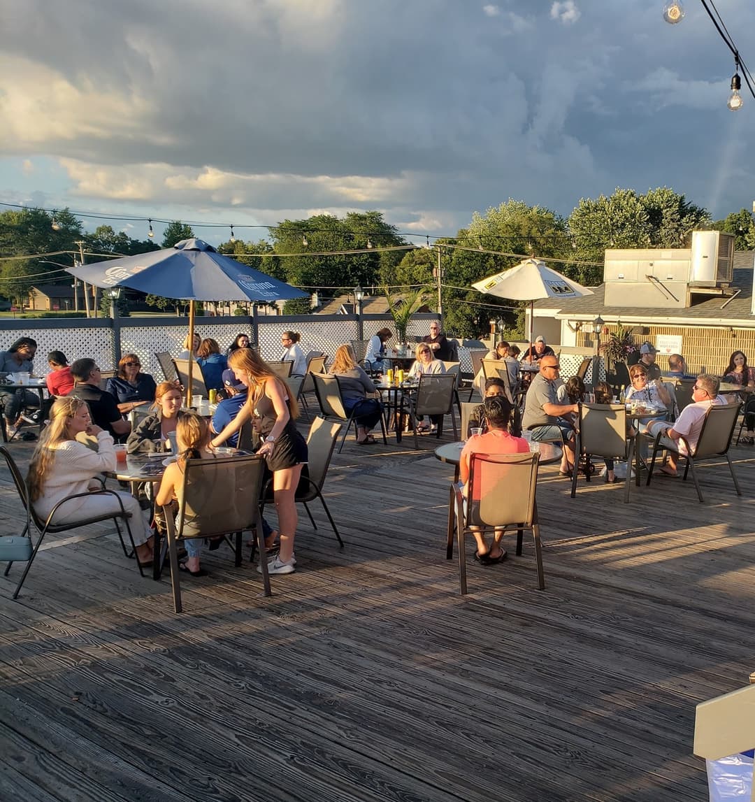 Guests dining on the outdoor rooftop patio at Rooftop Johnnys in Palos Heights, Illinois