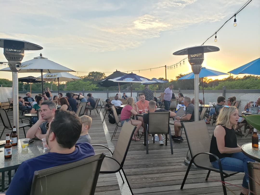 Guests enjoying food and drinks at Rooftop Johnnys in Palos Heights, Illinois